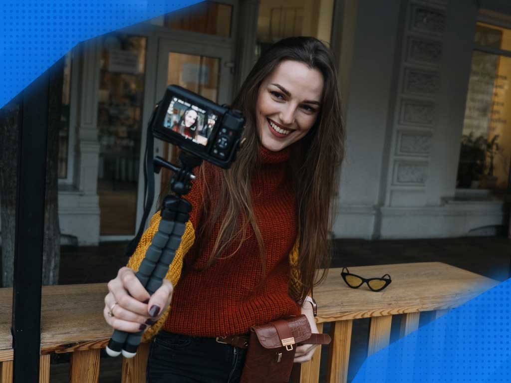 A woman holding a camera who wants to become a model